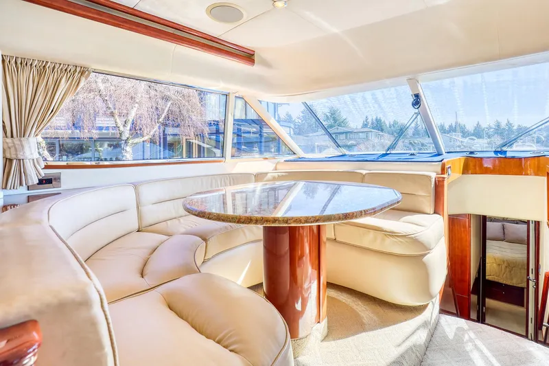 Slide: The Image of Luxurious interior of 2001 Viking Sport Cruisers Motoryacht with plush seating and elegant table. - 16