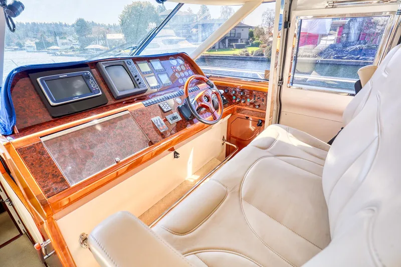 Slide: The Image of 2001 Viking Sport Cruisers Motoryacht helm with luxurious leather seating and advanced navigation controls. - 18