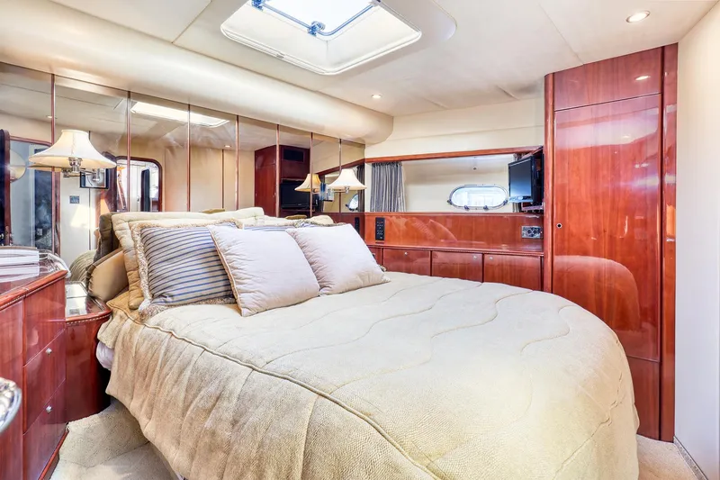 Slide: The Image of Luxurious bedroom in 2001 Viking Sport Cruisers Motoryacht with elegant wood finishes. - 19