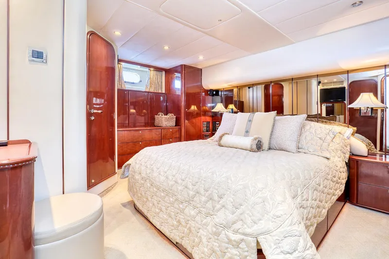 Slide: The Image of Luxurious bedroom interior of 2001 Viking Sport Cruisers Motoryacht with elegant wood finishes. - 20
