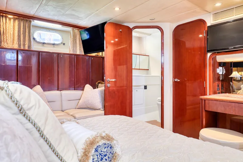 Slide: The Image of Luxurious 2001 Viking Sport Cruisers Motoryacht interior with elegant wood finishes and cozy seating. - 21