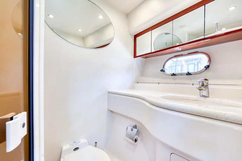 Slide: The Image of Luxurious bathroom in 2001 Viking Sport Cruisers Motoryacht with modern fixtures and oval mirror. - 22