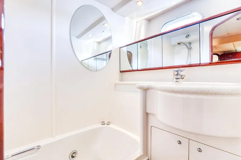 Slide: The Image of Luxurious bathroom in 2001 Viking Sport Cruisers Motoryacht with modern fixtures and elegant design. - 24