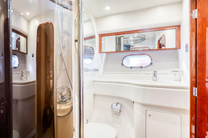 Slide: The Image of Luxurious bathroom in a 2001 Viking Sport Cruisers Motoryacht, featuring modern fixtures and elegant design. - 26