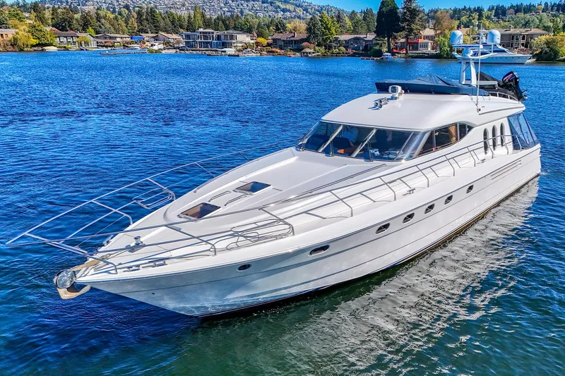 Slide: The Image of 2001 Viking Sport Cruisers Motoryacht on a serene lake with scenic background. - 3