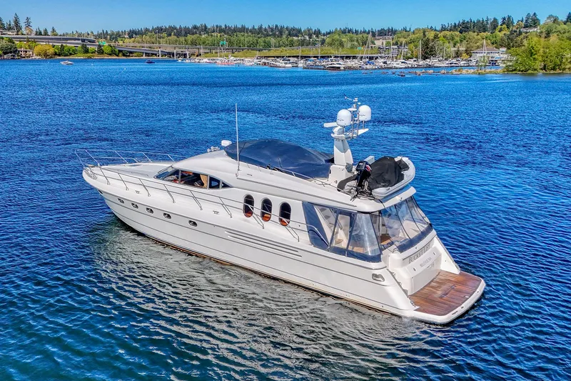 Slide: The Image of 2001 Viking Sport Cruisers Motoryacht on serene blue water, surrounded by lush greenery. - 4