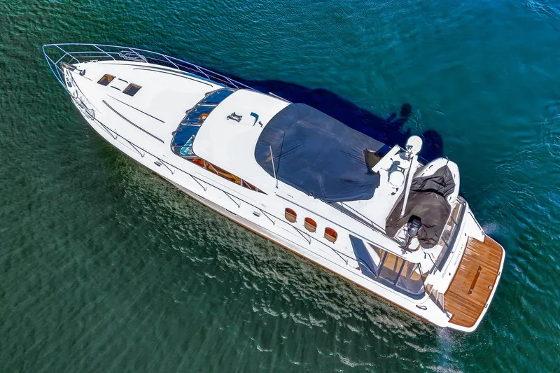 Slide: The Image of 2001 Viking Sport Cruisers Motoryacht on clear blue water, aerial view. - 5