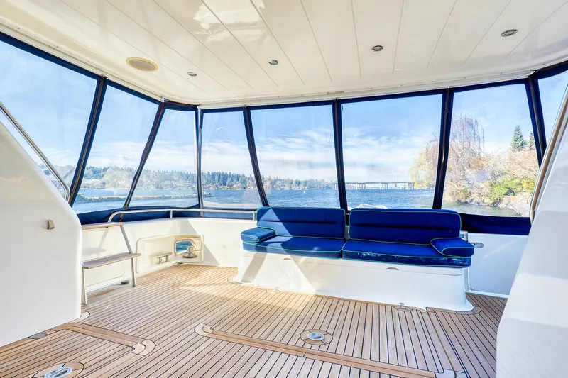 Slide: The Image of 2001 Viking Sport Cruisers Motoryacht interior with panoramic windows and blue seating. - 9