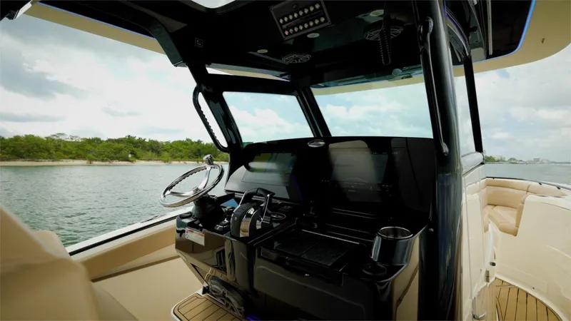 Slide: The Image of 2022 Scout 330 LXF boat helm with advanced navigation system and luxurious seating. - 17