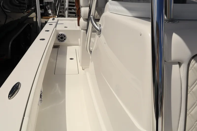 Slide: The Image of 2024 Valhalla Boatworks V-28 interior deck with white seating and stainless steel fixtures. - 15