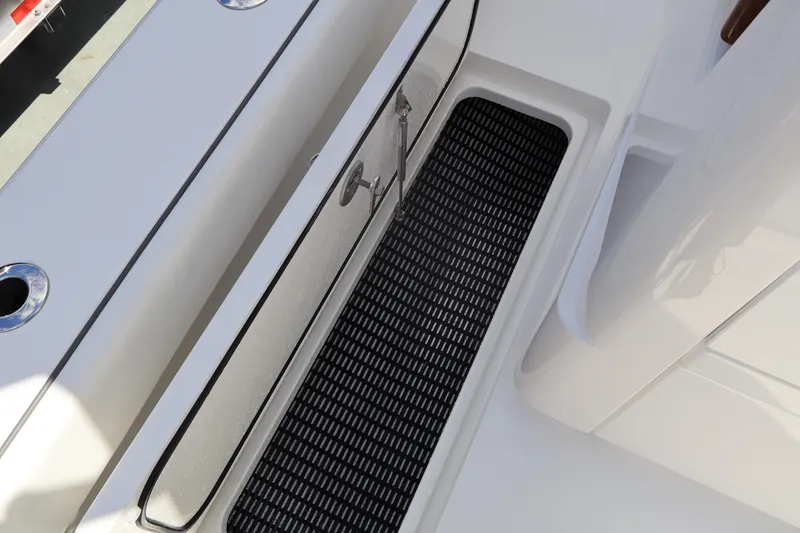 Slide: The Image of 2024 Valhalla Boatworks V-28 deck with storage compartment and non-slip mat. - 24