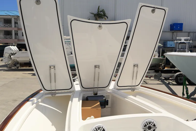 Slide: The Image of 2024 Valhalla Boatworks V-28 storage compartments open at marina. - 30