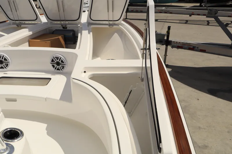 Slide: The Image of 2024 Valhalla Boatworks V-28 interior with open storage compartments and speakers. - 31