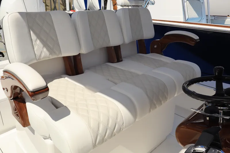 Slide: The Image of Luxurious seating on the 2024 Valhalla Boatworks V-28, featuring diamond-stitched upholstery and wooden accents. - 4