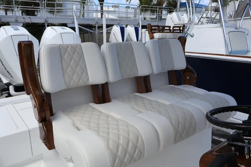 Slide: The Image of 2024 Valhalla Boatworks V-28 luxury seating with diamond-stitched upholstery and wooden accents. - 7