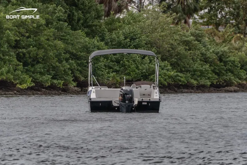 Slide: The Image of 2022 Starcraft SVX 171 OB boat on water near lush green shoreline. - 1