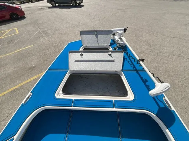 Slide: The Image of 2024 Majek 25 ILLUSION boat deck with open storage compartments and trolling motor. - 11