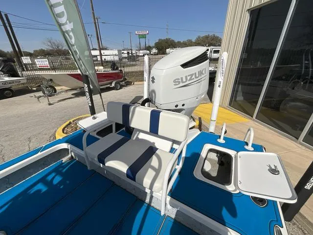 Slide: The Image of 2024 Majek 25 ILLUSION boat with Suzuki engine, blue deck, and white seating. - 13