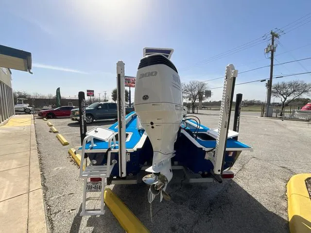 Slide: The Image of 2024 Majek 25 ILLUSION boat with powerful outboard motor in a parking lot. - 3