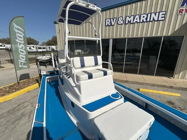 Slide: The Image of 2024 Majek 25 ILLUSION boat at RV & Marine dealership, featuring blue and white seating. - 6