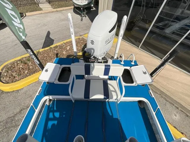 Slide: The Image of 2024 Majek 25 ILLUSION boat with Suzuki engine, blue deck, and seating area. - 8