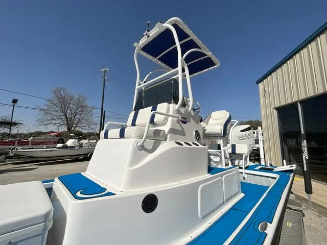 Slide: The Image of 2024 Majek 25 ILLUSION boat with blue accents and elevated helm station. - 9
