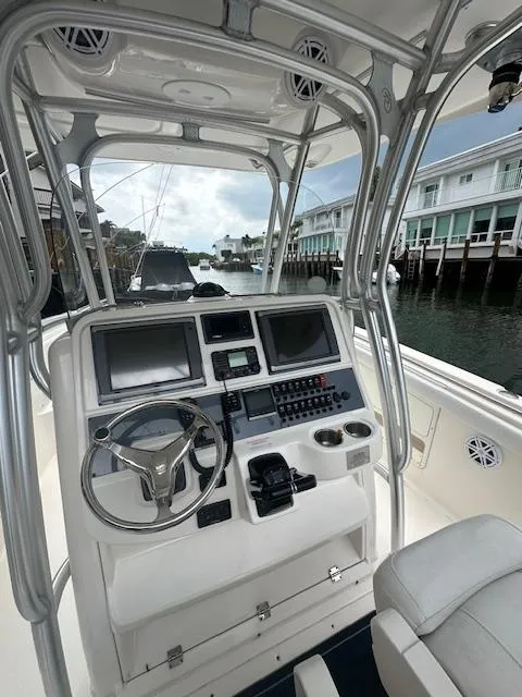 Slide: The Image of 2015 Robalo R300 Center Console boat helm with dual screens and controls. - 6