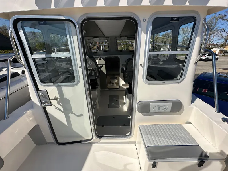 Slide: The Image of 2024 Defiance Admiral 270 EX boat interior view through open cabin door. - 10