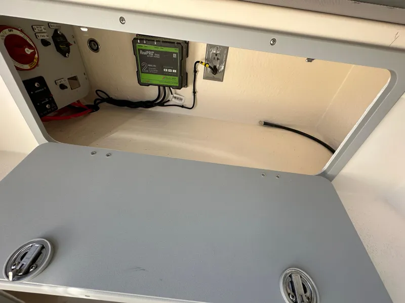 Slide: The Image of Electrical compartment of 2024 Defiance Admiral 270 EX boat with wiring and control panel. - 16
