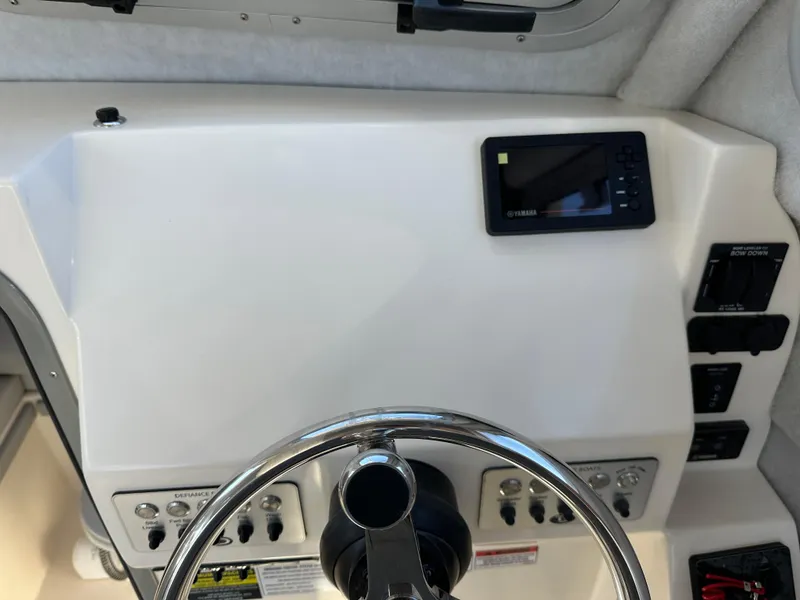 Slide: The Image of 2024 Defiance Admiral 270 EX boat helm with steering wheel and control panel. - 18