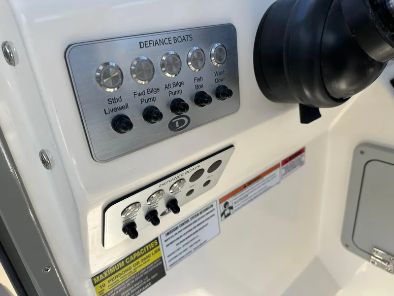 Slide: The Image of Control panel of 2024 Defiance Admiral 270 EX boat with various switches. - 19