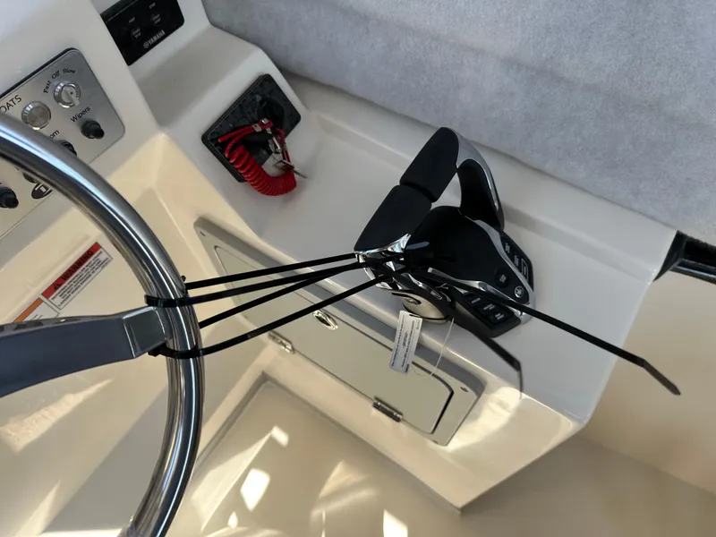Slide: The Image of Control panel and steering wheel of 2024 Defiance Admiral 270 EX boat. - 21