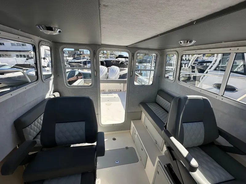 Slide: The Image of Interior of 2024 Defiance Admiral 270 EX boat with seating and windows. - 24