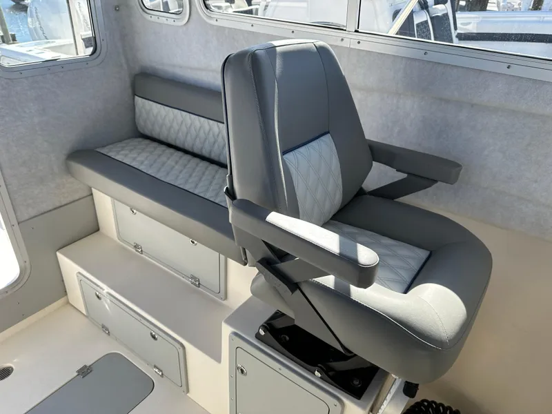 Slide: The Image of 2024 Defiance Admiral 270 EX interior seating and storage compartments. - 25