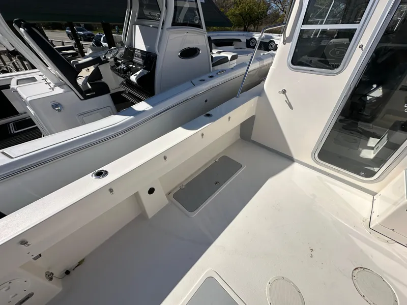 Slide: The Image of 2024 Defiance Admiral 270 EX boat deck with storage compartments and seating. - 4