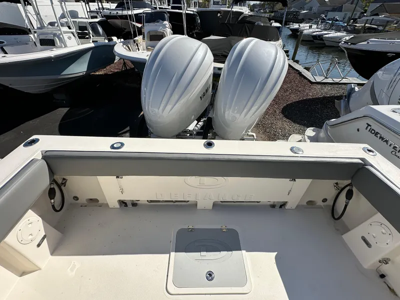 Slide: The Image of 2024 Defiance Admiral 270 EX boat with twin outboard engines at a marina. - 6