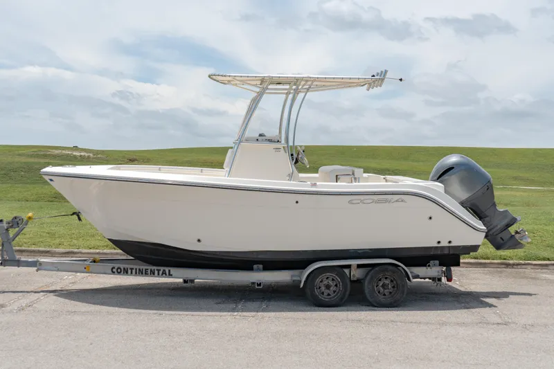 Slide: The Image of 2021 Cobia 201 Center Console boat on a Continental trailer. - 1
