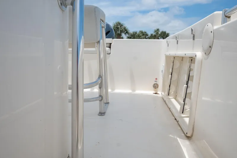Slide: The Image of 2021 Cobia 201 Center Console boat deck with seating and storage compartments. - 13
