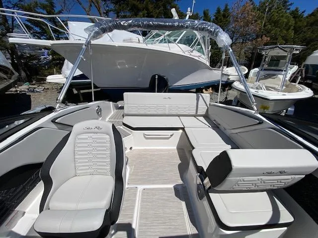 Slide: The Image of 2024 Sea Ray SPX 210 OB boat interior with white seating and open deck. - 11