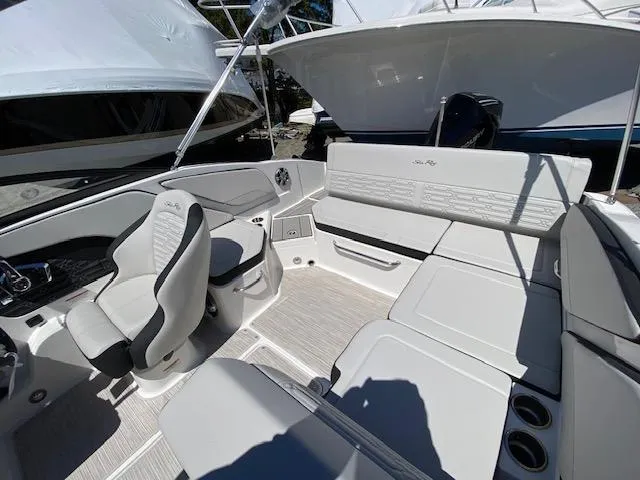 Slide: The Image of 2024 Sea Ray SPX 210 OB boat interior with seating and steering console. - 12