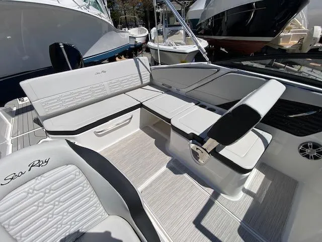 Slide: The Image of 2024 Sea Ray SPX 210 OB boat interior with white seating and modern design. - 13