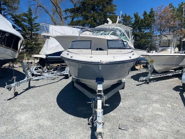 Slide: The Image of 2024 Sea Ray SPX 210 OB boat on trailer in outdoor lot. - 3