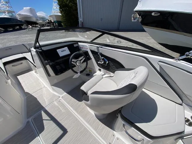 Slide: The Image of 2024 Sea Ray SPX 210 OB boat interior with modern helm and seating. - 4