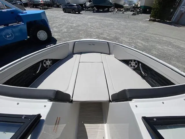 Slide: The Image of 2024 Sea Ray SPX 210 OB boat interior, bow seating area with cushioned seats. - 6