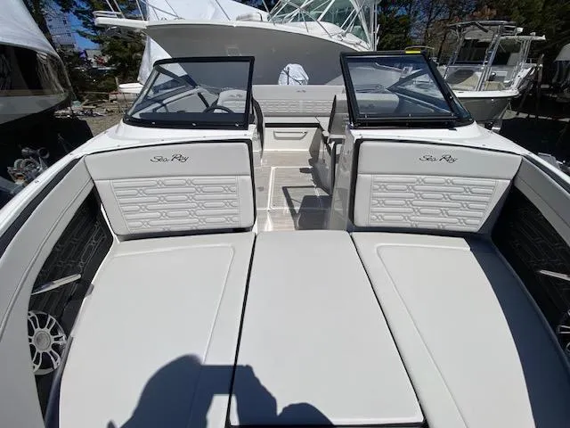 Slide: The Image of 2024 Sea Ray SPX 210 OB boat interior with white seating and dual windshields. - 7