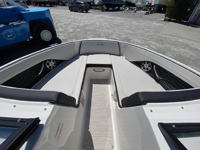 Slide: The Image of 2024 Sea Ray SPX 210 OB boat interior with cushioned seating and speakers. - 8