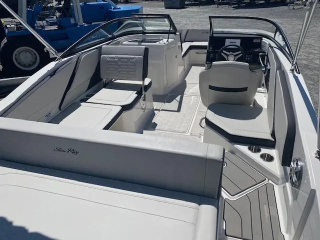 Slide: The Image of 2024 Sea Ray SPX 210 OB boat interior with seating and steering console. - 9