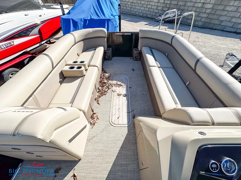Slide: The Image of 2023 Crest CLASSIC LX 240 SLC pontoon boat with beige seating and clean deck. - 5