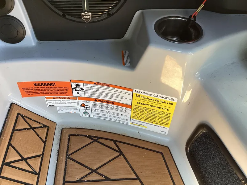 Slide: The Image of 2020 Tigé 21ZX boat interior with warning and capacity labels. - 10