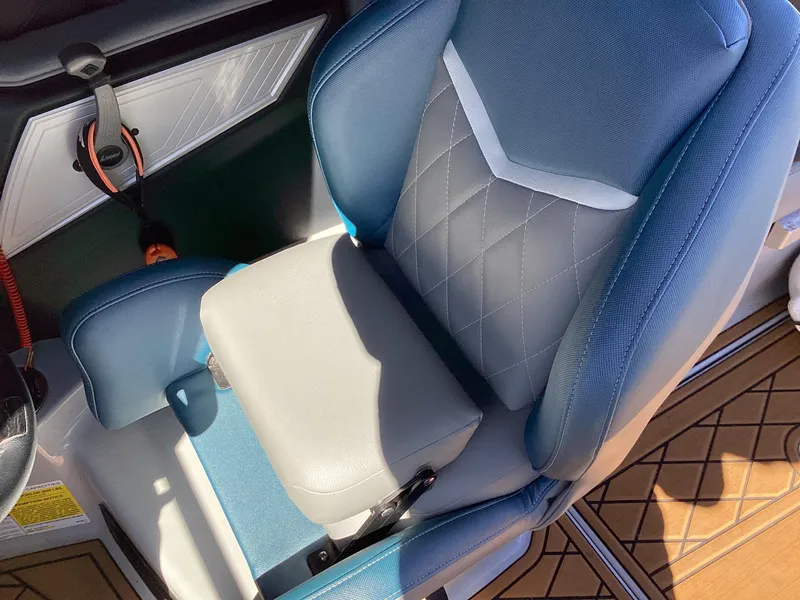 Slide: The Image of 2020 Tigé 21ZX boat captain's seat with blue and gray upholstery. - 11